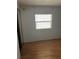 Simple bedroom with wood flooring and window at 12501 Ulmerton Rd # 119, Largo, FL 33774