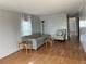 Living room with gray sofa, accent chair, and laminate flooring at 12501 Ulmerton Rd # 119, Largo, FL 33774