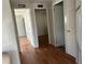 Bright hallway with light gray walls and wood-look flooring at 12501 Ulmerton Rd # 119, Largo, FL 33774