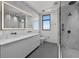 Modern bathroom with a dual sink vanity, glass shower, and stylish finishes at 126 4Th Ne Ave # 1302, St Petersburg, FL 33701