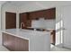 Well-lit kitchen with modern finishes, beautiful wood cabinets, and a center island with a white countertop at 126 4Th Ne Ave # 1302, St Petersburg, FL 33701