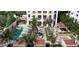 Aerial view of a luxurious pool area surrounded by palm trees and stylish lounge seating at 126 4Th Ne Ave # 1302, St Petersburg, FL 33701