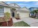 One-story house with light yellow exterior, stone accents, and a two-car garage at 1655 Bonita Bluff Ct, Ruskin, FL 33570