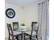 Small breakfast nook with glass table and four chairs at 16752 Carlton Pond St, Wimauma, FL 33598