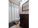 Clean bathroom with dark wood vanity and shower/tub combo at 2030 Dodge St, Clearwater, FL 33760