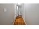 Long hallway with light wood flooring and access to bedrooms at 2030 Dodge St, Clearwater, FL 33760