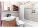 Cozy bathroom with wood vanity, a medicine cabinet, tiled walls, and a bathtub with a shower at 225 35Th N St, St Petersburg, FL 33713