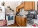 Small kitchen with wood cabinets and appliances at 225 35Th N St, St Petersburg, FL 33713