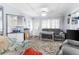 Cozy living room featuring a gray sofa and patterned rug at 225 35Th N St, St Petersburg, FL 33713