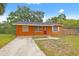 Charming single-story brick home with a red front door and well-maintained lawn in a quiet neighborhood at 225 35Th N St, St Petersburg, FL 33713