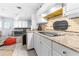 Bright kitchen with granite countertops and white cabinets at 225 35Th N St, St Petersburg, FL 33713