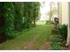 Landscaped backyard with lush green grass and trees at 3161 Lake Pine S Way # B1, Tarpon Springs, FL 34688