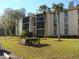 Two-story apartment building with lush landscaping at 3161 Lake Pine S Way # B1, Tarpon Springs, FL 34688