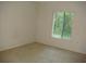 Spacious bedroom with neutral carpeting and a window overlooking the backyard at 3161 Lake Pine S Way # B1, Tarpon Springs, FL 34688