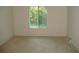 Simple bedroom with neutral carpeting and a window at 3161 Lake Pine S Way # B1, Tarpon Springs, FL 34688