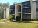 Two-story building exterior with balconies and landscaping at 3161 Lake Pine S Way # B1, Tarpon Springs, FL 34688