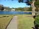 Landscaped grounds with a walkway and lake view at 3161 Lake Pine S Way # B1, Tarpon Springs, FL 34688