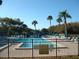 Community pool with palm trees and lounge chairs at 3161 Lake Pine S Way # B1, Tarpon Springs, FL 34688