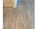 Modern light grey wood-look vinyl plank flooring at 3161 Lake Pine S Way # B1, Tarpon Springs, FL 34688