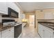 Kitchen with granite countertops, white cabinets and a view of the bathroom at 4305 Bayside Village Dr # 104, Tampa, FL 33615