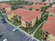 Aerial view of apartment buildings with parking and landscaping at 4305 Bayside Village Dr # 104, Tampa, FL 33615
