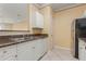 White kitchen cabinets, granite countertops, and stainless steel appliances at 4305 Bayside Village Dr # 104, Tampa, FL 33615