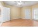 Bright bedroom with wood floors, ceiling fan, and ample closet space at 4305 Bayside Village Dr # 104, Tampa, FL 33615