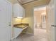 Laundry area with built-in cabinets and bathroom access at 4305 Bayside Village Dr # 104, Tampa, FL 33615