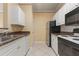 Kitchen with white cabinets, granite counters and black appliances at 4305 Bayside Village Dr # 104, Tampa, FL 33615