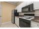 Well-equipped kitchen, featuring black appliances and granite countertops at 4305 Bayside Village Dr # 104, Tampa, FL 33615