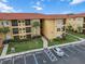 Condo building exterior with parking and landscaping at 4305 Bayside Village Dr # 104, Tampa, FL 33615