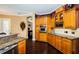 Spacious kitchen with wood cabinets, granite countertops, and dark hardwood floors at 5944 Bay S Dr, Gulfport, FL 33707