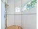 Walk-in shower with tiled walls and arched window at 5944 Bay S Dr, Gulfport, FL 33707