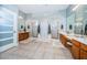 Large Primary bathroom with double vanity, two walk-in showers, and tile floors at 5944 Bay S Dr, Gulfport, FL 33707