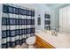 Guest bathroom with single sink and striped shower curtain at 5944 Bay S Dr, Gulfport, FL 33707