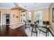 Elegant dining room features a glass-top table and hardwood floors at 5944 Bay S Dr, Gulfport, FL 33707