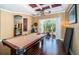 Game room features a pool table and sliding glass doors to patio at 5944 Bay S Dr, Gulfport, FL 33707