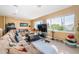 Living area with sectional sofa, large windows, and a TV at 5944 Bay S Dr, Gulfport, FL 33707