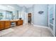 Primary bathroom with vanity, large mirror and access to the bedroom at 5944 Bay S Dr, Gulfport, FL 33707