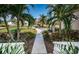 Inviting walkway to home with lush landscaping and palm trees at 5944 Bay S Dr, Gulfport, FL 33707