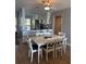 Open concept dining room with white table and chairs, adjacent to kitchen at 6268 Palma Del Mar Blvd S # 215, St Petersburg, FL 33715