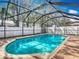 Inviting screened pool with a brick patio area at 6702 Mirror Lake Ave, Tampa, FL 33634