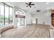 Bright living room with vaulted ceilings, wood-look floors, and sliding glass doors leading to the backyard at 8309 La Serena Dr, Tampa, FL 33614