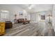 Living room with grey wood-look floors, brown leather couches and sliding glass doors at 8404 Millwood Dr, Hudson, FL 34667