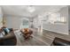 Open living space with wood-look floors, leather couch, and pool view at 8404 Millwood Dr, Hudson, FL 34667
