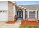 Inviting front entrance with double blue doors and brick accents at 8404 Millwood Dr, Hudson, FL 34667