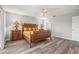 Bright bedroom with wood-look floors and ceiling fan at 8404 Millwood Dr, Hudson, FL 34667