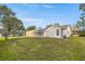 Spacious backyard with grassy area and pool at 8404 Millwood Dr, Hudson, FL 34667