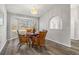 Charming dining room with a bay window and wood-look flooring at 8404 Millwood Dr, Hudson, FL 34667