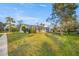 Landscaped backyard with screened pool and patio at 8404 Millwood Dr, Hudson, FL 34667